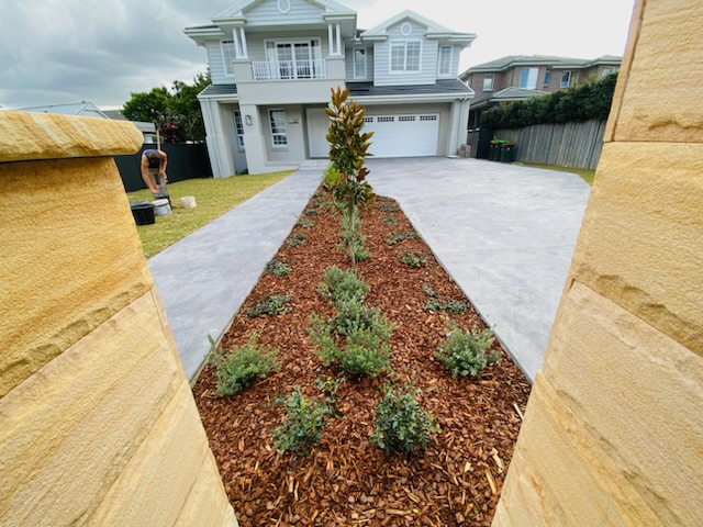 mulched garden bed with view to house