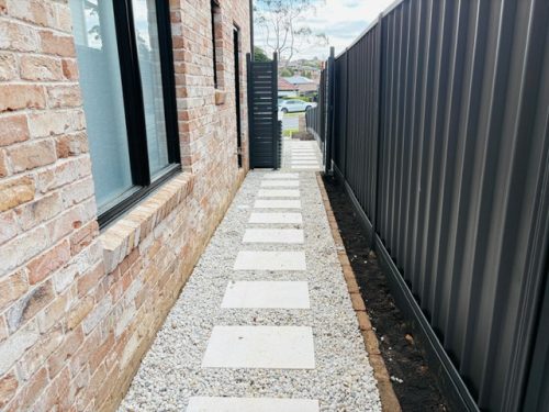 Garden path with steppers surrounding with pebbles