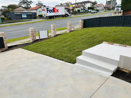 Frontyard concrete driveway, lawn and steps