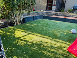 backyard-lawn timber-retaining-wall